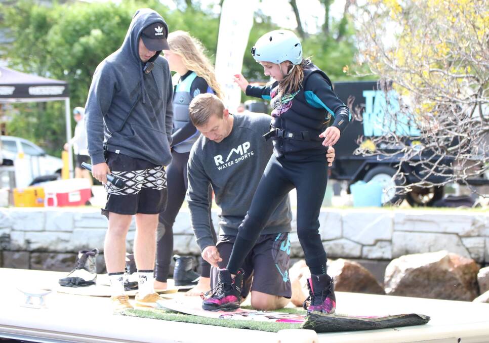 GEARED UP: Dad John Van Asperen helps secure the wakeboard of daughter Charlotte ahead of the opening round of the Tasmanian series last month. Picture: Jess Stevenson