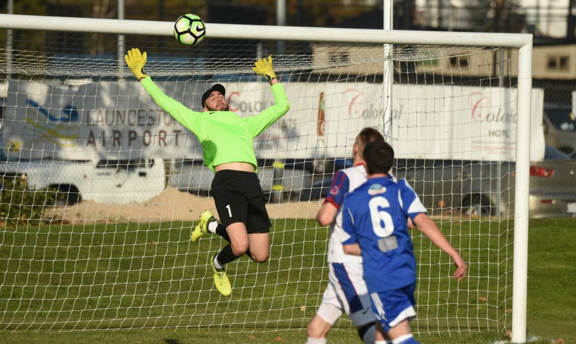 SAVING SAMMY: Northern Rangers goalkeeper Sam Whatman pulls off the most spectacular of his many saves over Olympia. Pictures: Paul Scambler