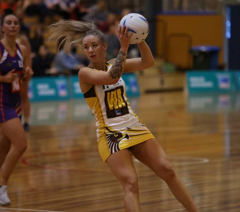 ON THE MOVE: Northern Hawks star Zoe Claridge slides to the ball during the fast-paced Tasmanian decider.