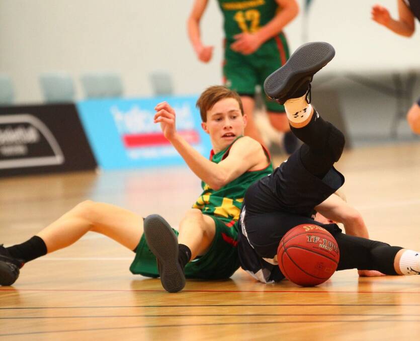 EXCUSE ME: Tasmanian star Reyne Smith accidentally collides with the referee during the Australian under-16 championships in Western Australia. Picture: Basketball Australia