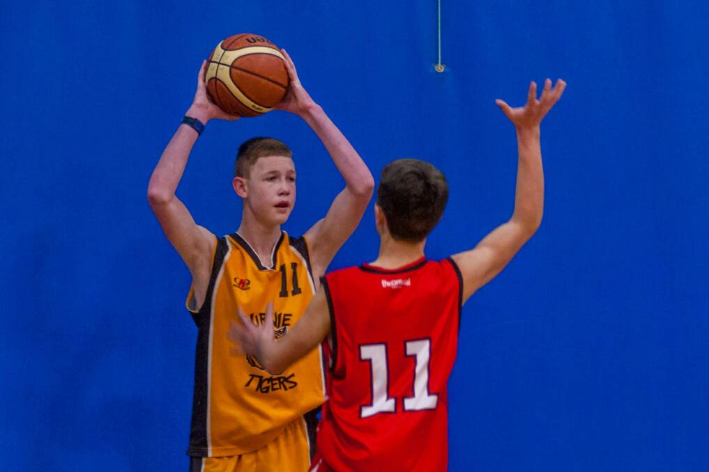 IN YOUR FACE: Launceston defender Conlan Lamont makes his presence felt to Burnie's Owen Clarke at last weekend's state under-14 championships. Picture: Phillip Biggs