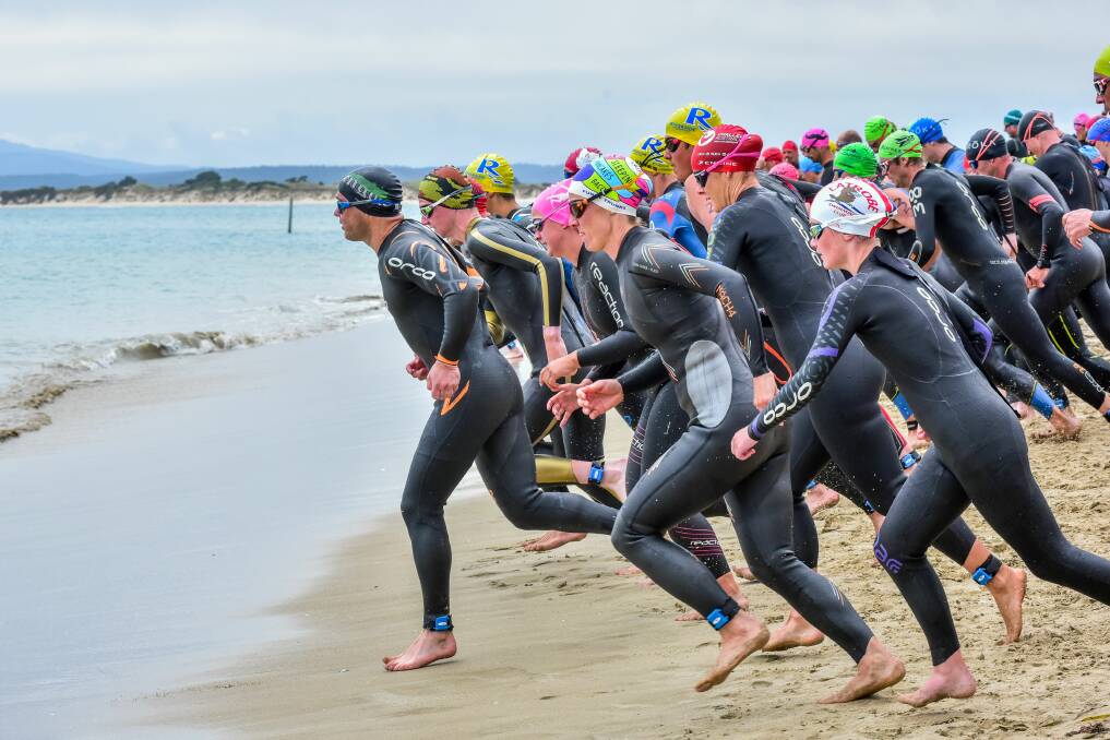 OFF WE GO: Competitors launch into the corresponding Bridport triathlon earlier this year. Picture: Neil Richardson