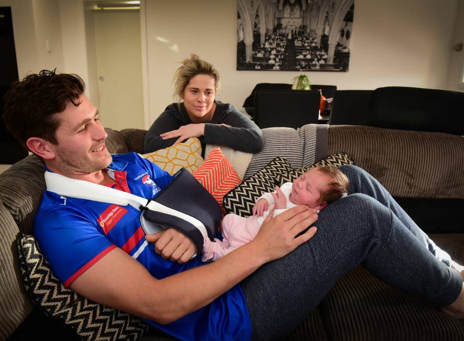 LOYAL: South Launceston retiree Adam Viney with club president and wife Felicity left besotted over newborn daughter Cate. Picture: Paul Scambler