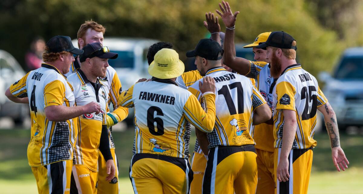 GET AROUND US: Longford gets brief relief celebrating a crucial wicket amid its tense grand final clash against Hadspen. Picture: Phillip Biggs