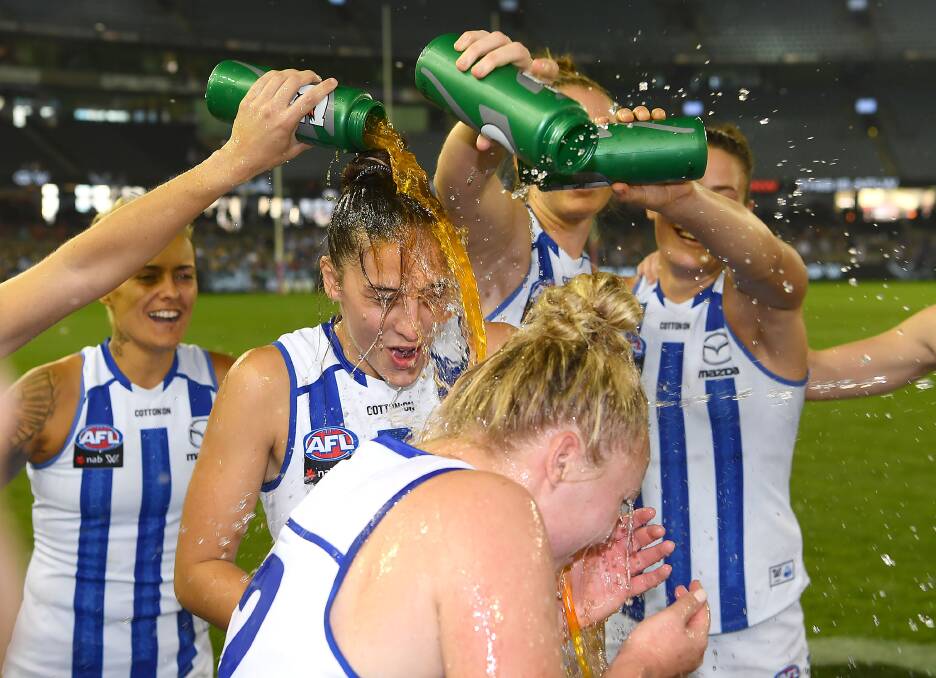 COP THAT: Banister gets drenched by teammates after making her debut for North Melbourne.