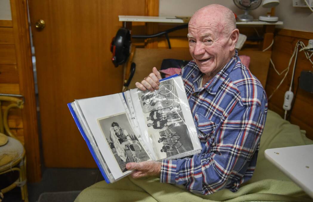 MEMORIES: Terry Higgins manages to pull out a smile as he also pulls out a favourite old cycling scrapbook. Picture: Paul Scambler