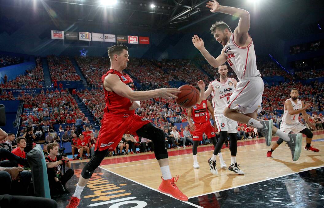 KEEP AWAY: The one-time Perth Wildcat talent attempts to stop the ball from going out of bounds. Picture: AAP