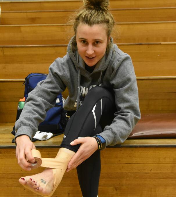 GAME TIME: Lauren Mansfield straps her ankle back in July at a Launceston Tornadoes training session.