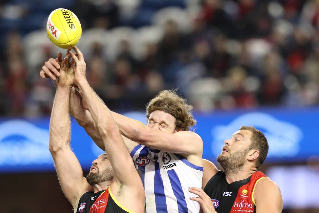 STATE MATES: North Melbourne's Ben Brown and Essendon's Tom Bellchambers, in competition on Sunday, are among Tasmania's graduates to the AFL. Picture: AAP