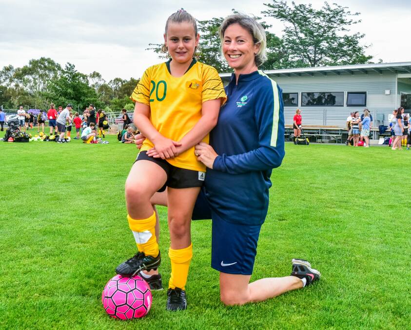 DREAMING: Imogen Donoghue gets some tips from Football Tasmania women's development office Debra Banks.