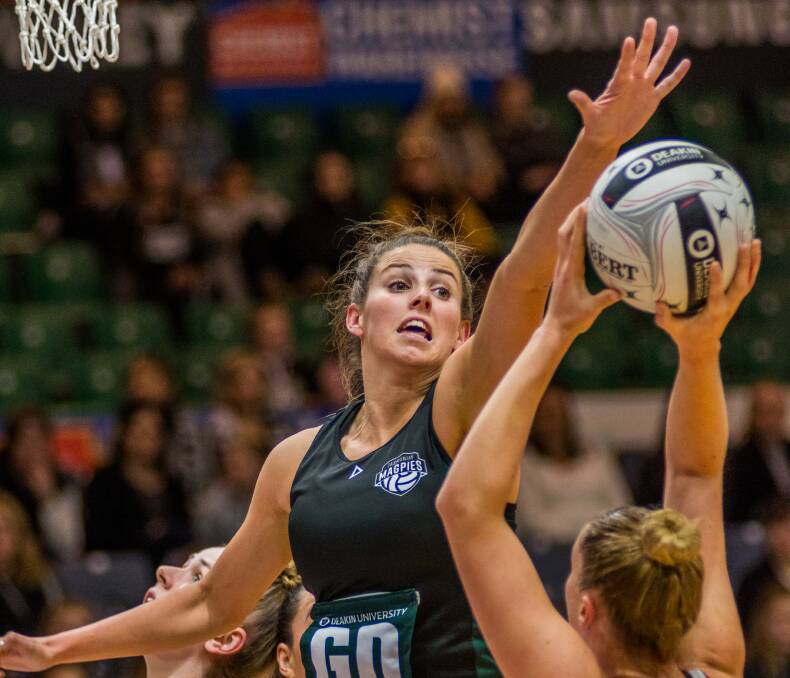 DESPERATE: Tasmanian defender Mel Bragg puts on her game face to stop a Queensland Fusion shot. Picture: Phillip Biggs