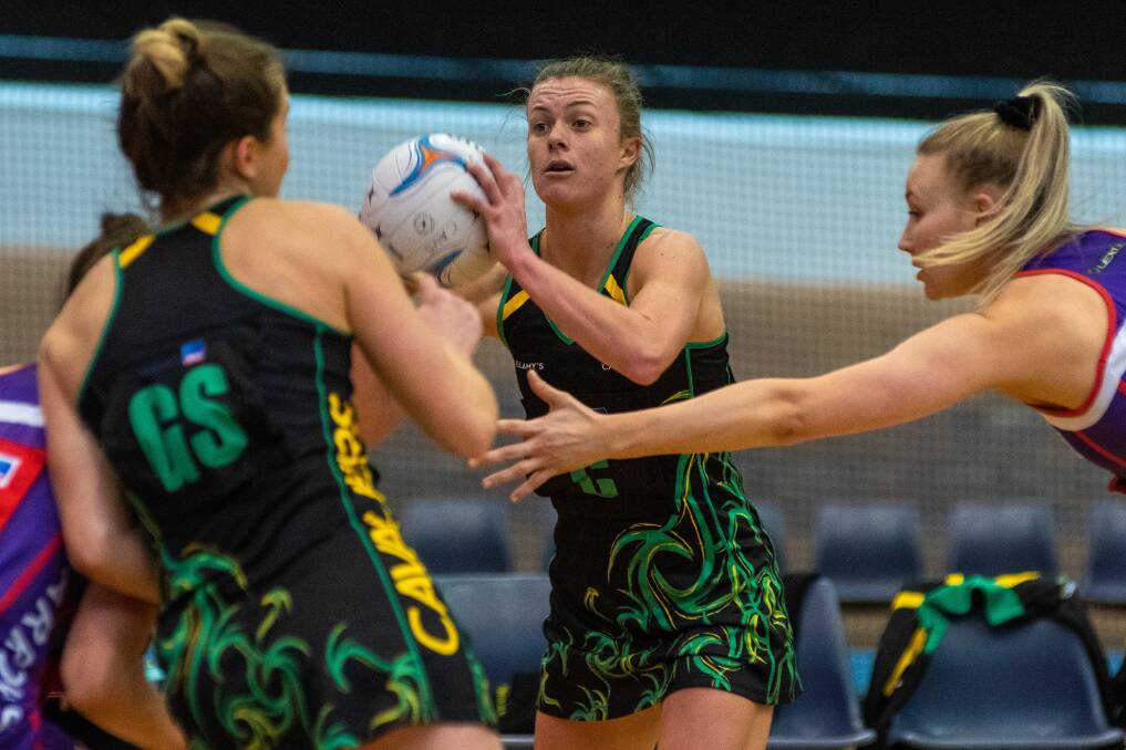 GAME FACE: A determined Lucy Dennis stars for Cavaliers in midcourt while under pressure from the Arrows defence during Sunday's key State League netball encounter at the Silverdome. Picture: Phillip Biggs
