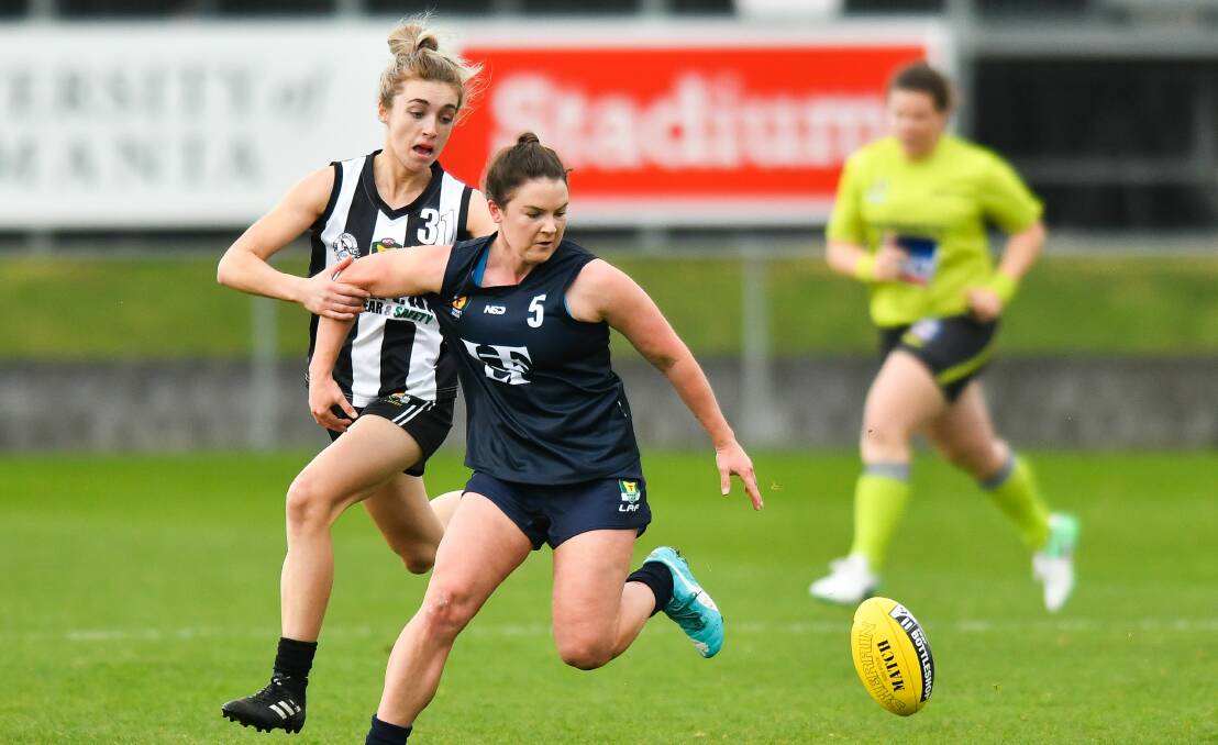 TRUE BLUE: Courtney Webb shows off her desperation for the hard ball in Launceston's TSLW premiership victory over Glenorchy last year.