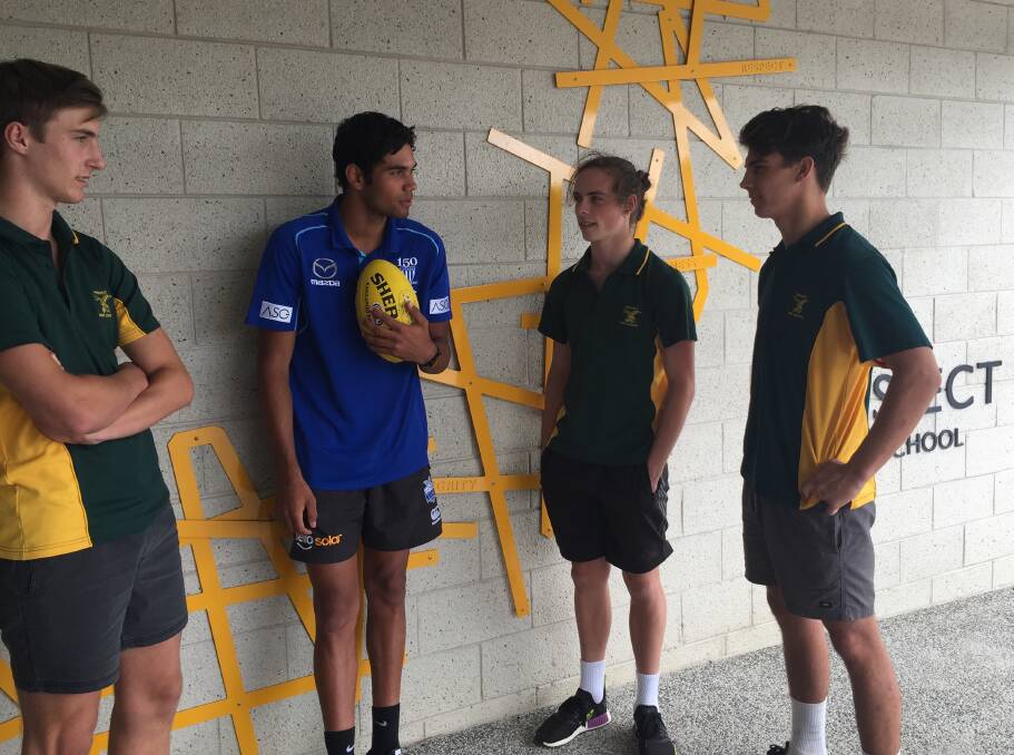 HOMECOMING: Prospect High trio Brayden Fellows, Jack Woods and Job Chapman share a chat about footy with returning student Tarryn Thomas.