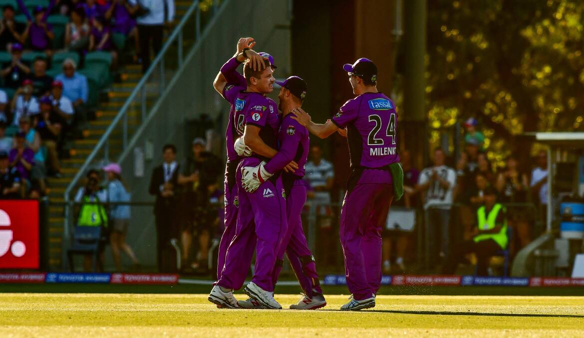 SUCCESS: Launceston-born allrounder James Faulkner earns the plaudits of his Hobart Hurricanes teammates after earning an early wicket at UTAS Stadium this time last year.