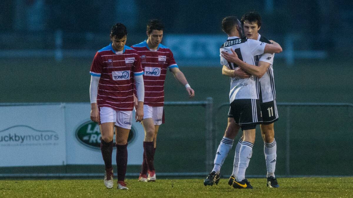 AGONY AND ECSTASY: Northern Rangers and Launceston City players show a stark
contrast in their fortunes during Saturday's soccer showdown. Picture: Phillip Biggs