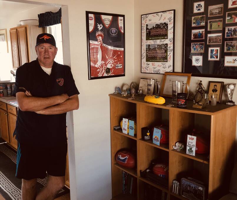Leigh Barnes shows off the mementos from two decades of involvement in the Australian game in the US. Pictures: Supplied
