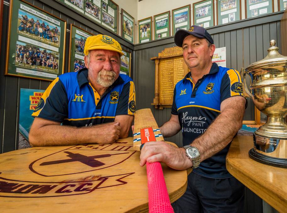 WE'RE 90 NOT OUT: Stalwarts Rob Howard and Matthew Cocker proudly show a corner of Trevallyn Cricket Club's past inside the clubrooms. Picture: Phillip Biggs
