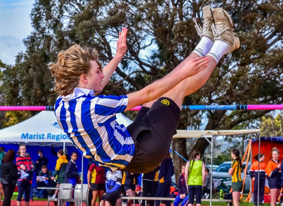 OVER: Launceston Grammar leaper Peter Strong looks to clear the high jump bar.