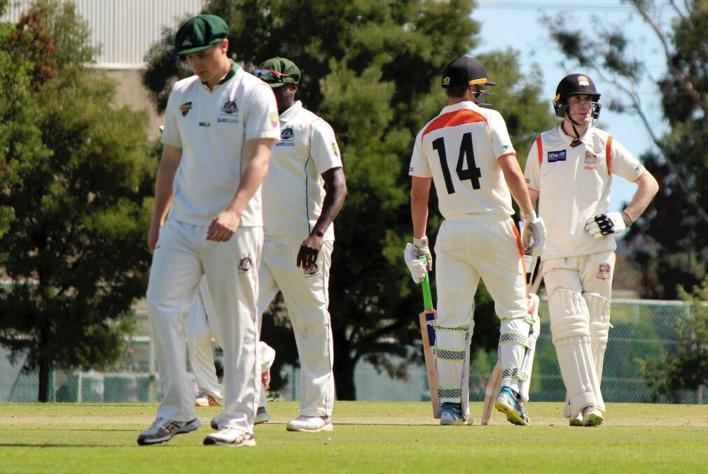 STANDING UP: Greater Northern Raiders opening batsmen Miles Barnard and Brodie Hayes both assess the massive run chase between overs against New Town at the NTCA No.2 Ground on Saturday. Picture: Hamish Geale