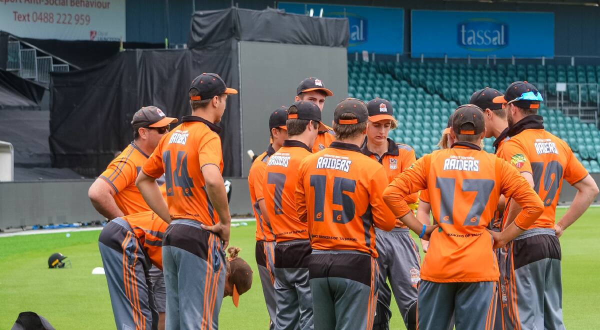 CAMARADERIE: Greater Northern Raiders coach Andrew Gower listens in to his team's pep talk from the back of the pack between innings at UTAS Stadium in the midst of his second Cricket Tasmania Premier League season in charge. Picture: Andrew Mathieson