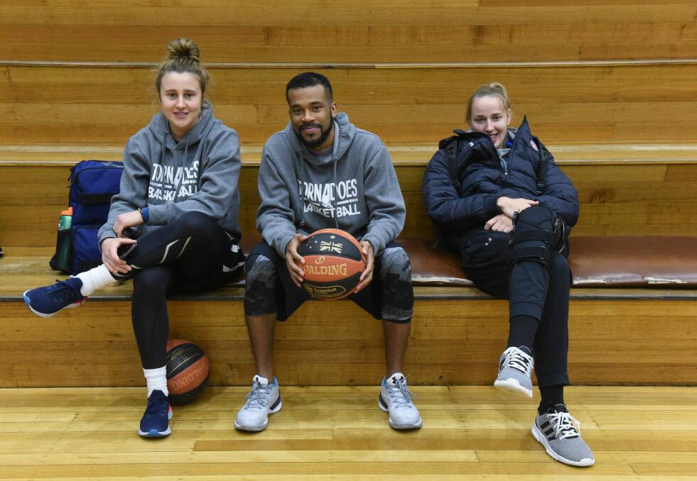 ON BOARD: Mikaela Ruef (right) joins captain Lauren Mansfield and coach Derrick Washington prior to Tornadoes training. Picture: Paul Scambler