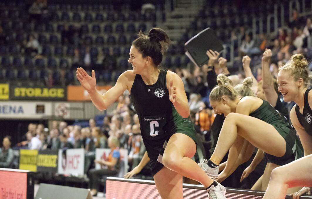 TIME TO CELEBRATE: Tasmanians Maddie Carter, Shelby Miller and Zanna Jodlowska moments after the elated finish jump over hoardings to join Magpies teammates on court at the ANL grand final in Canberra. Picture: Sitthixay Ditthavong