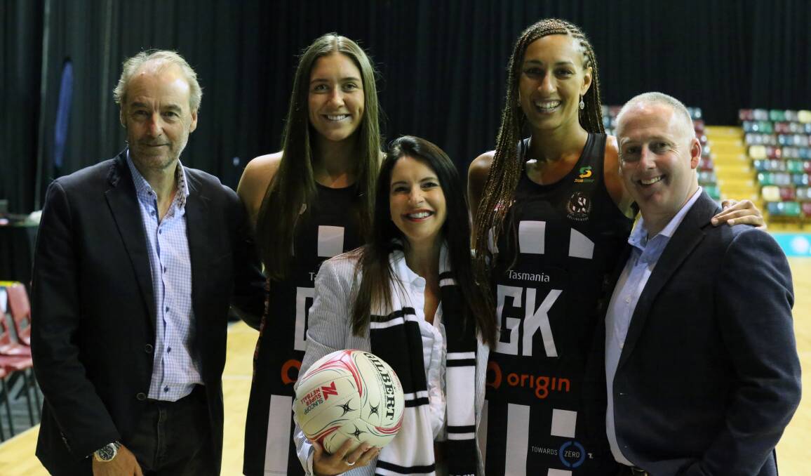 HAPPY: Collingwood boss Mark Anderson bookends with Netball Tasmania's Aaron Pidgeon after signing the deal.