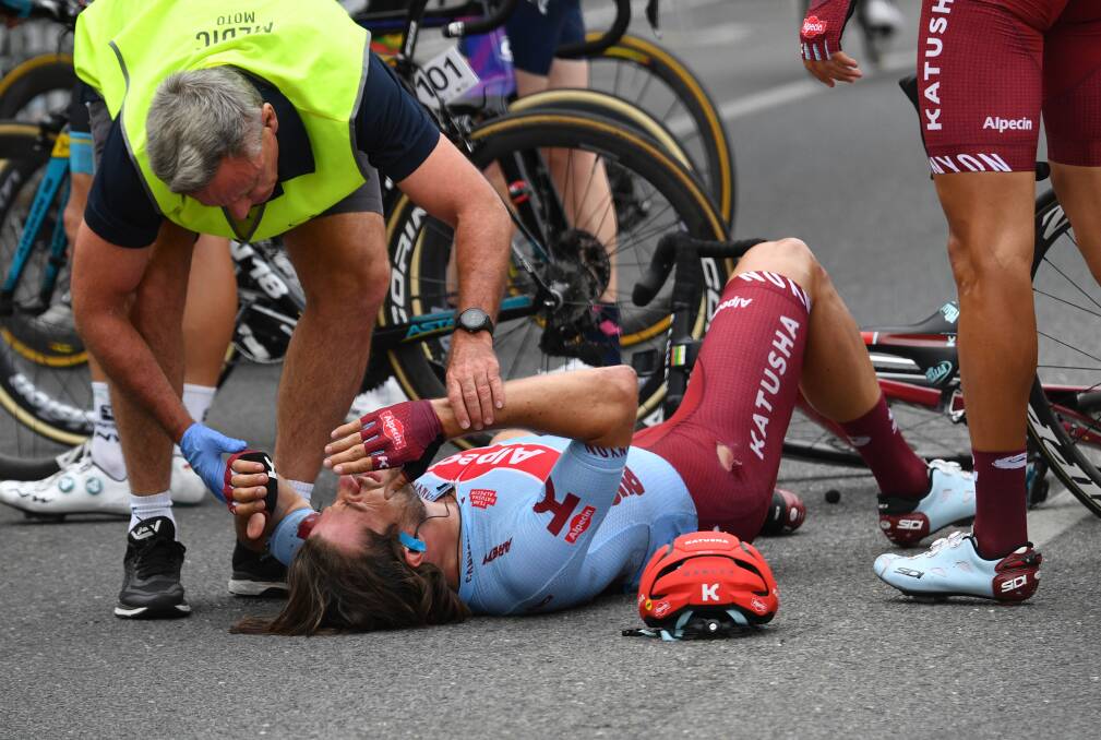 DISASTER: Team Katusha rider Marco Haller is seen to after a crash just before the finish line in Angaston during stage two of the Tour Down Under on Wednesday. Picture: AAP