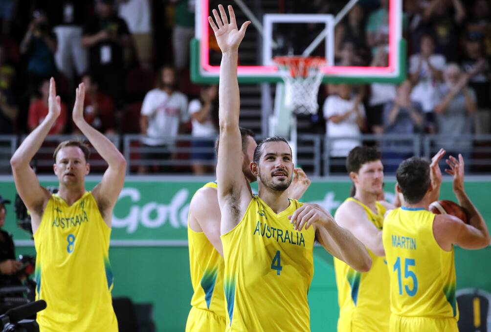 THANK YOU: Chris Goulding leads the applause for fans on the Gold Coast after Australia's emphatic win over Canada in the gold medal basketball game. Picture: AP