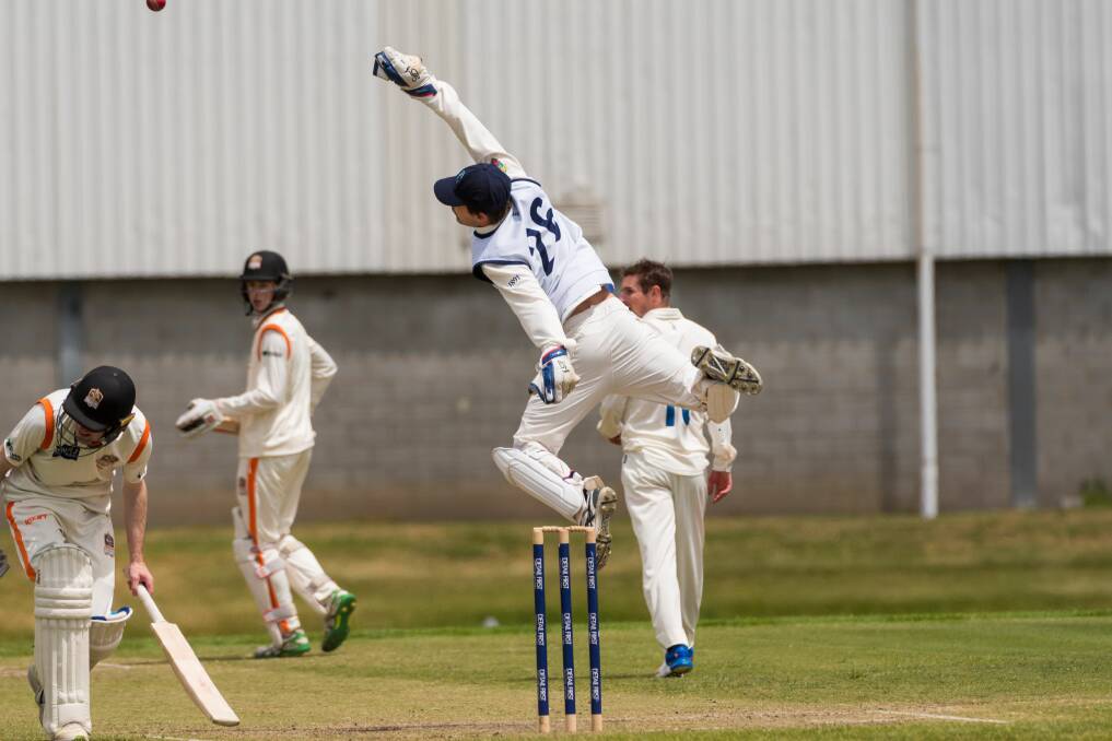 OVERTHROW: Lindisfarne keeper Sam Underhill leaps high for an errant throw that flies over the head of batsman Brodie Hayes. Picture: Phillip Biggs