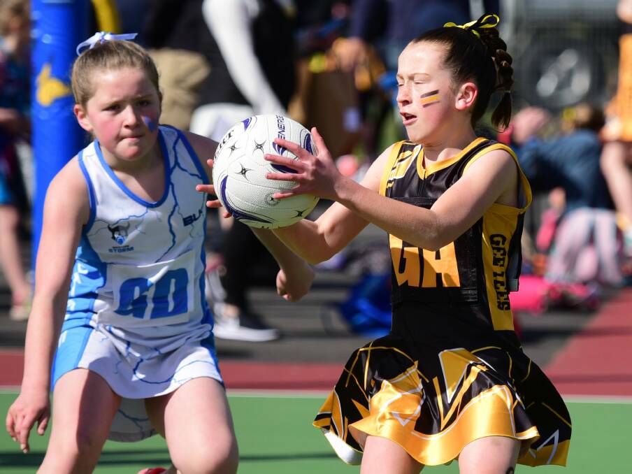 EYES ON THE PRIZE: Gee Tees goal attack Chloe Cunningham beats Western Storm goal defence Isla McCreevy to the ball in the 11-and-under grand final. 