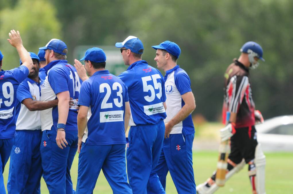 GET AROUND US: ACL show off their Blueback pride last season amid the celebrations of a huge wicket against Hadspen. Pictures: Paul Scambler
