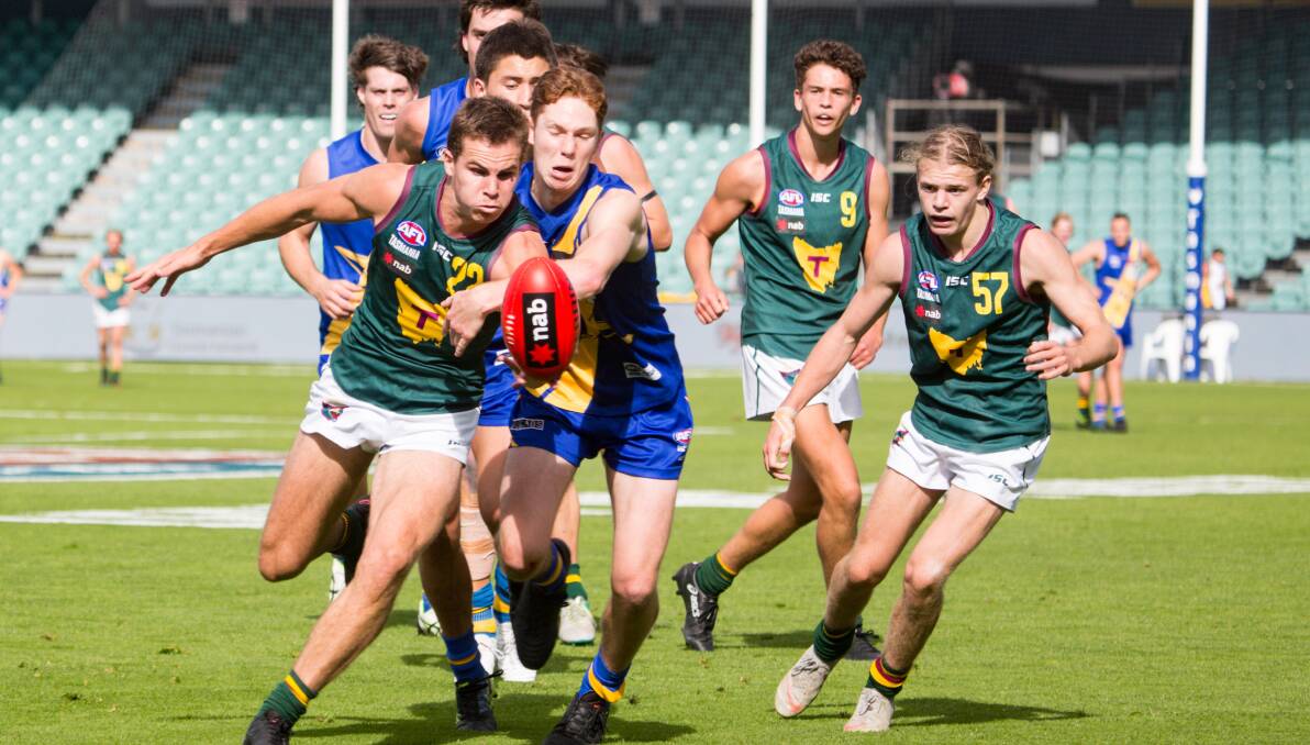 BALL MAGNET: Tasmanian Devils prime mover Nicholas Baker leads his Western Jets rivals to the ball in last Sunday's home match at ITAS Stadium. Picture: Solstice Digital 