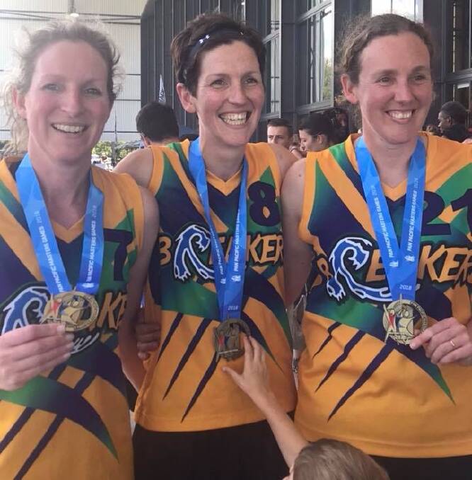 SIBLING FUN: Former Launceston Tornadoes star Desiree Glaubitz, centre, celebrates medals from the 2018 Masters Games with sisters Madeleine and Maleigha. Picture: Supplied