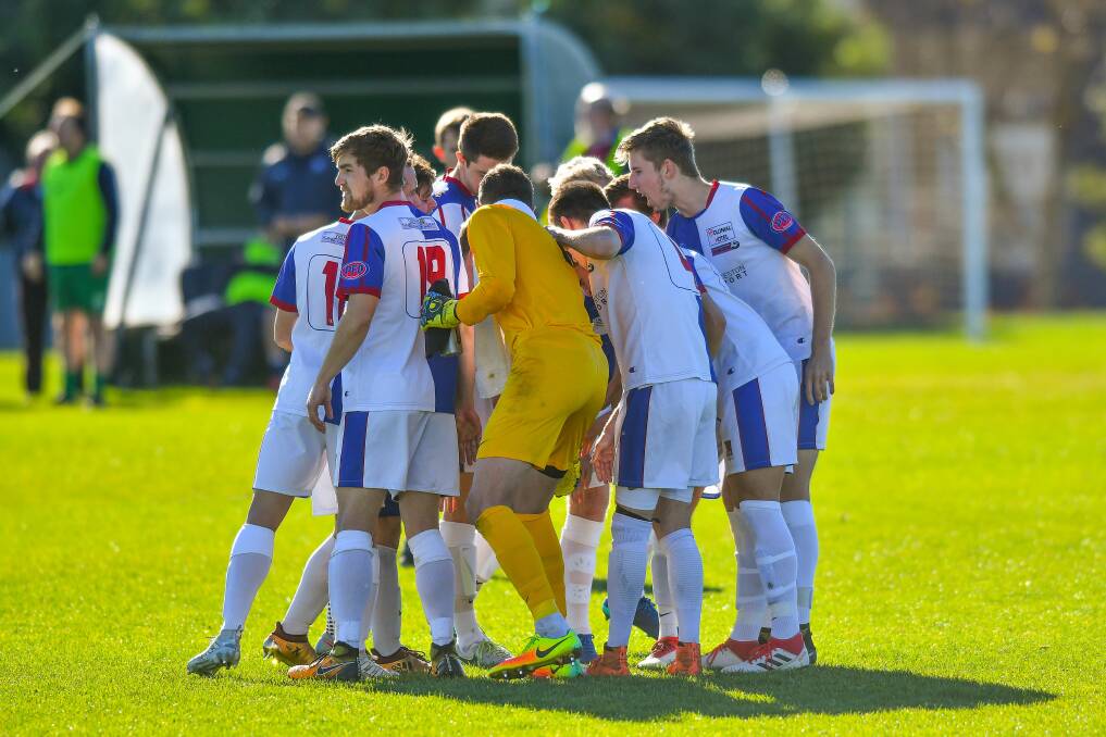 STAND AS ONE: Northern Rangers last year prior to an NPL Tasmania kick-off.