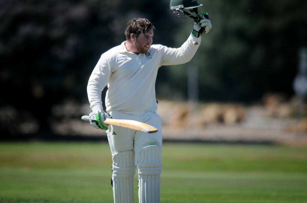 HATS OFF: Alistair Taylor salutes Launceston teammates after bringing up a milestone with the bat last summer. 