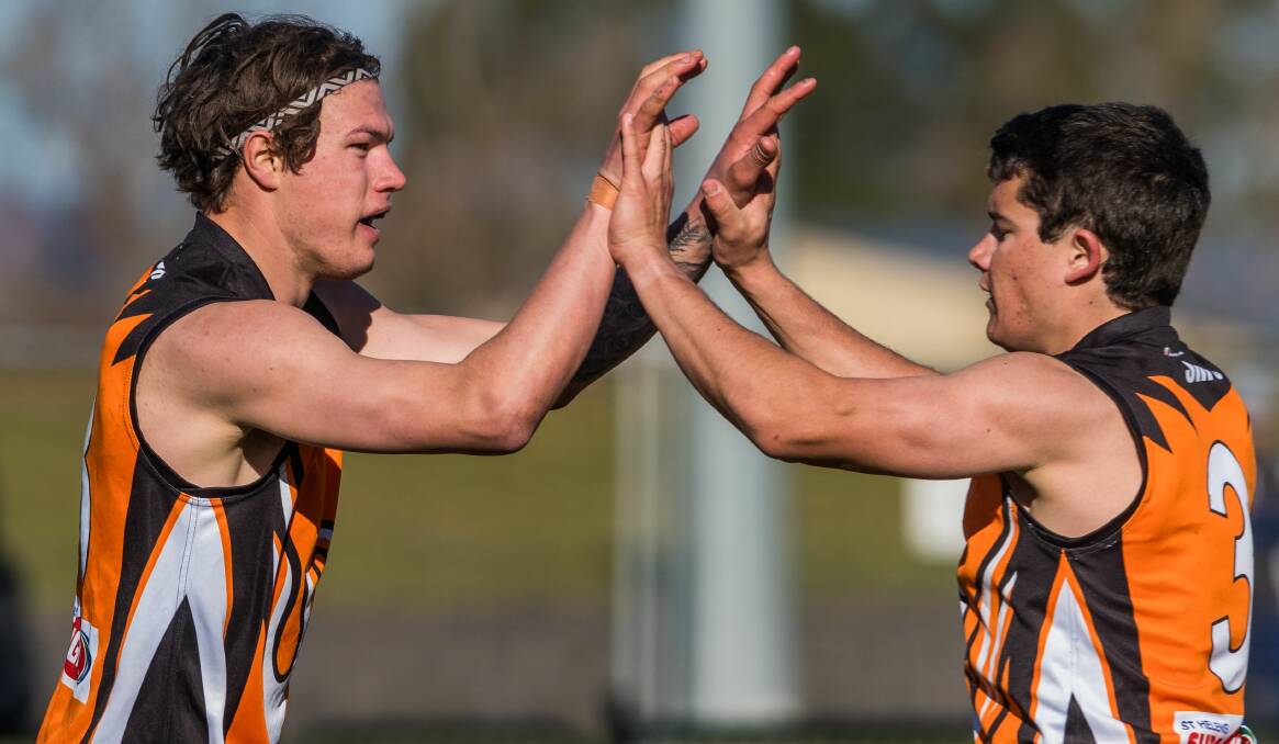 ALL GOOD: Swans teammates Anthony Marshall and Hamish Tate exchange high fives.