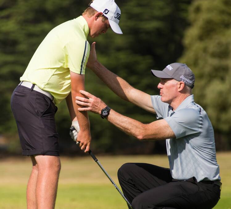 TECHNIQUE: Top Australian PGA coach Peter Knight corrects the stance of Prospect Vale's James Fiddian during an elite clinic at Launceston Golf Club. Picture: Phillip Biggs. 