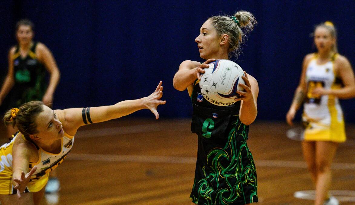 SOCIALLY DISTANT: Retired Northern Hawks captain Ashton Whiley gets as close as she can to Cavaliers midcourter Shelby Miller in the post COVID-19 era at last year's grand final. Pictures: Scott Gelston