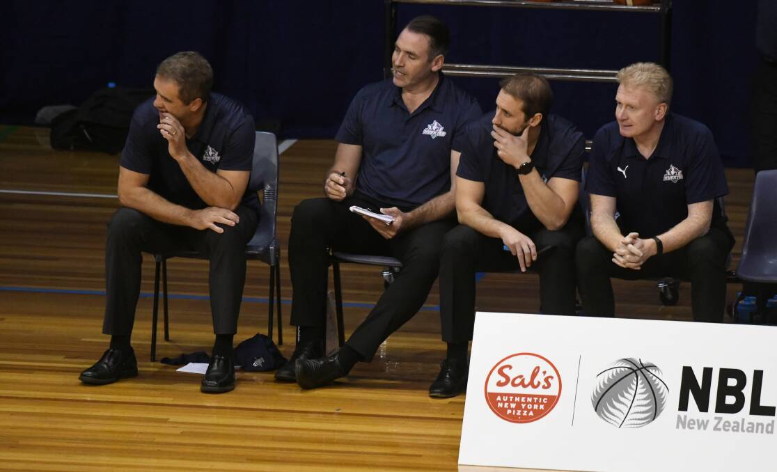 ANOTHER TIME: Southern Huskies assistant Brett Smith, far right, joins his coaching colleagues at the Silverdome floor on Sunday evening, three decades since playing on the same court for Launceston. Picture: Paul Scambler 