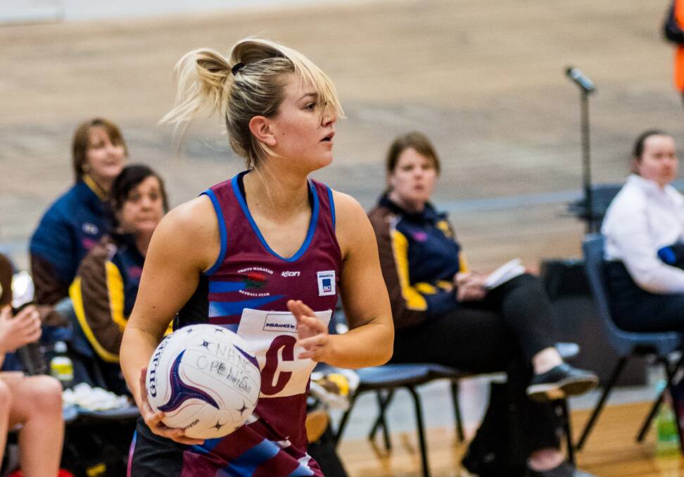 ON THE FRINGES: Cripps Waratah's playermaker Ashley Probert-Hillduring gets more than she ever bargained for fetching the ball against Northern Hawks in the State League netball Silverdome double-header on Saturday. Picture: Phillip Biggs