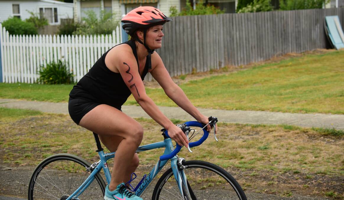 HARD WORK: Isobel Starrett strains her way on the bike. Picture: Paul Scambler