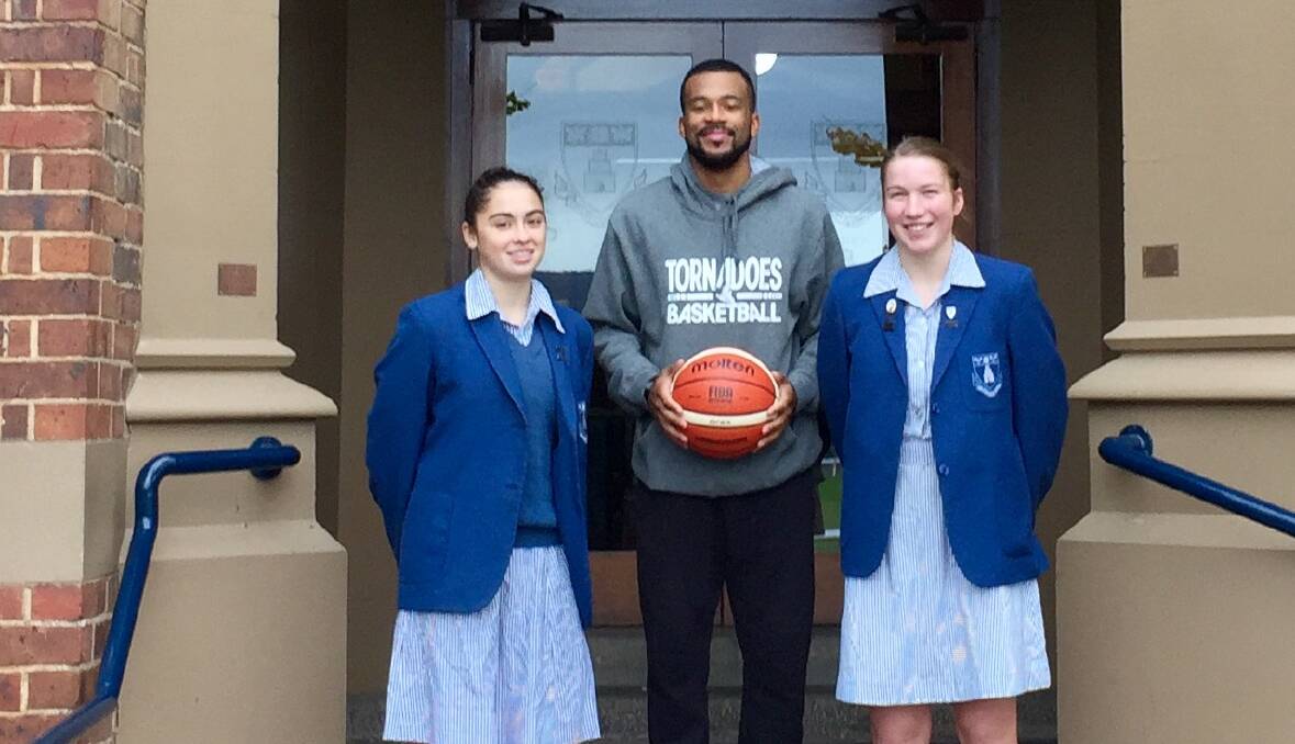 LESSONS: Aishah Anis and Jess Johnston at school with Derrick Washington.