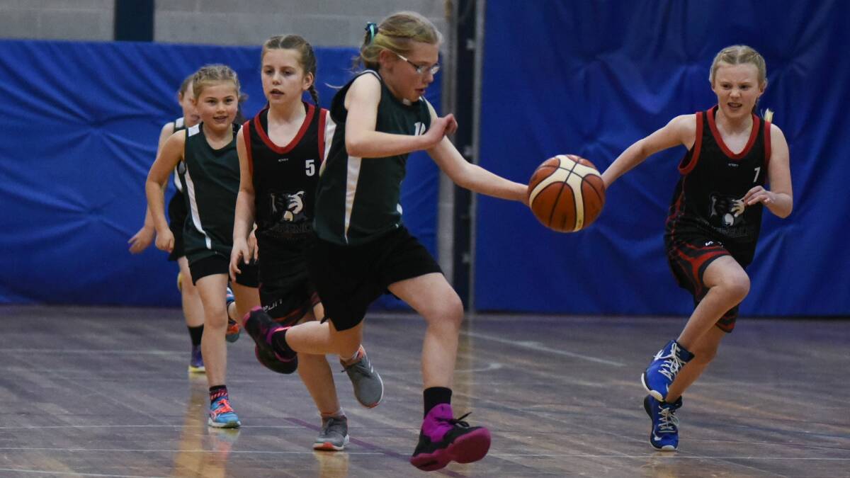 FAST BREAK: Devonport's Chloe Denney runs past rival defenders to find extra space up the court.