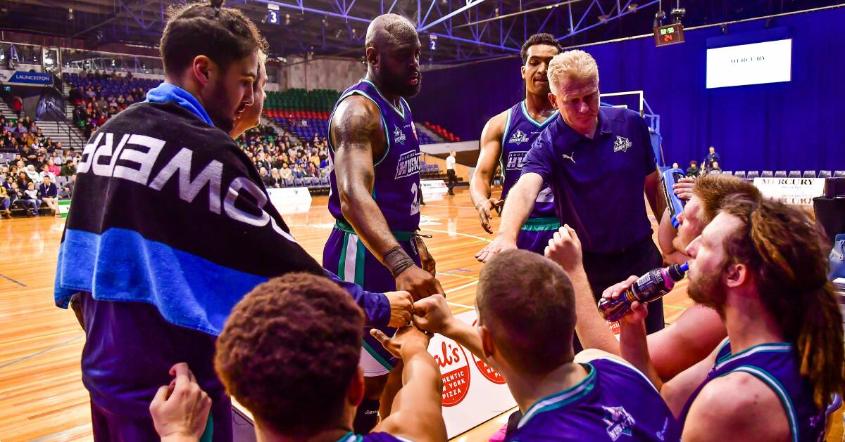 GET IN, FELLAS: Assistant coach Brett Smith calls in Craig Moller and Harry Froling for a fist bump at the end of a timeout last Saturday at the Silverdome. Picture: Scott Gelston