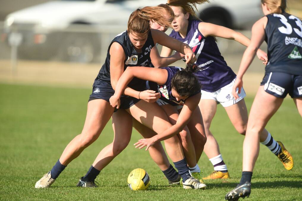 UNDER THE PUMP: Blues tackler Kate McLaughlin applies pressure to Burnie rival Emily Duncombe.