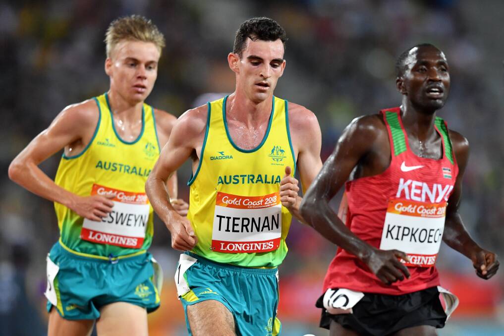 LET'S GO: Stewart McSweyn trails countryman Patrick Tiernan in the men's Commonwealth Games 10,000m final at Carrara Stadium on Friday night. Picture: AAP