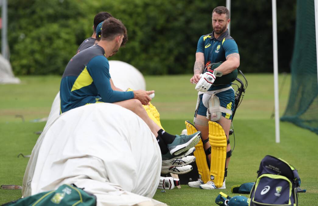 HARD WORK: Wade shares a discussion with sidelined Ashes squad teammates.