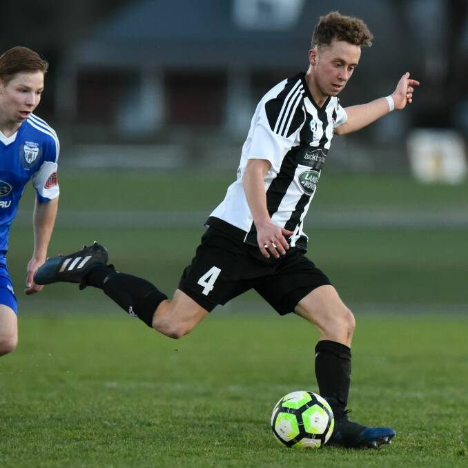 ON THE BALL: American Dylan Williams wins the race ahead of his Olympia Warriors rival in Launceston City's home NPL Tasmania encounter on Saturday evening. Picture: Neil Richardson